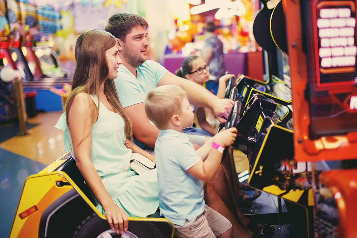 Family playing racing arcade game