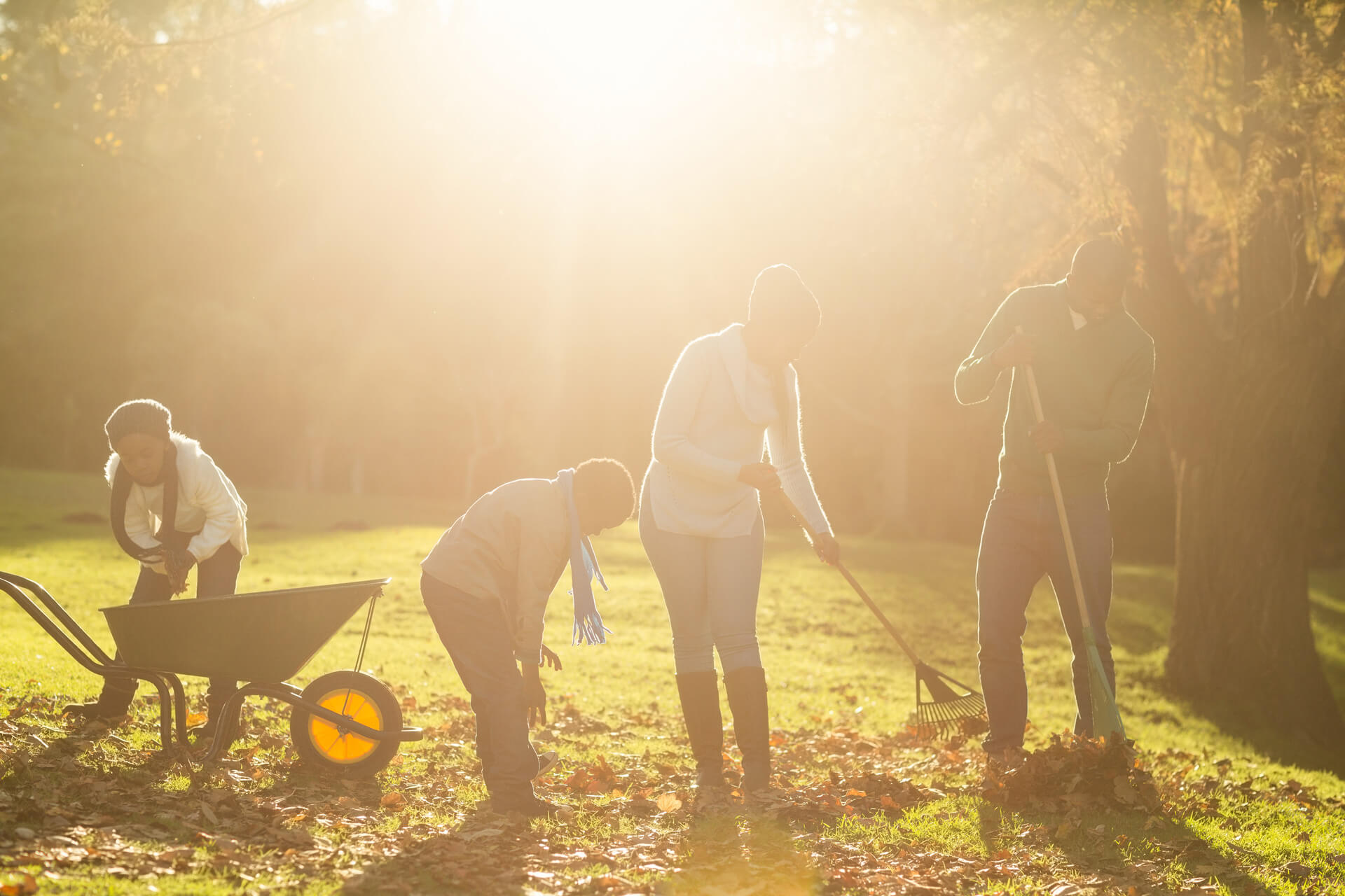 Family raking leaves