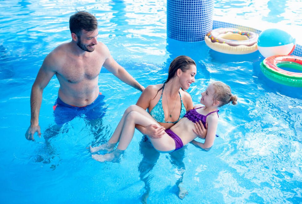 Small family enjoying open swim in a pool