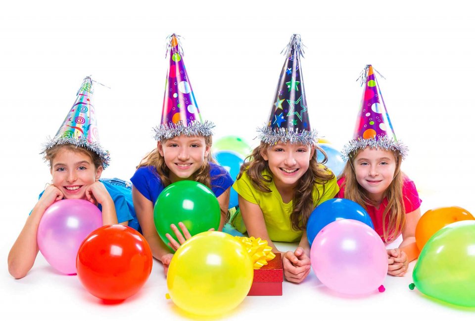 kids wearing party hats enjoying a birthday party